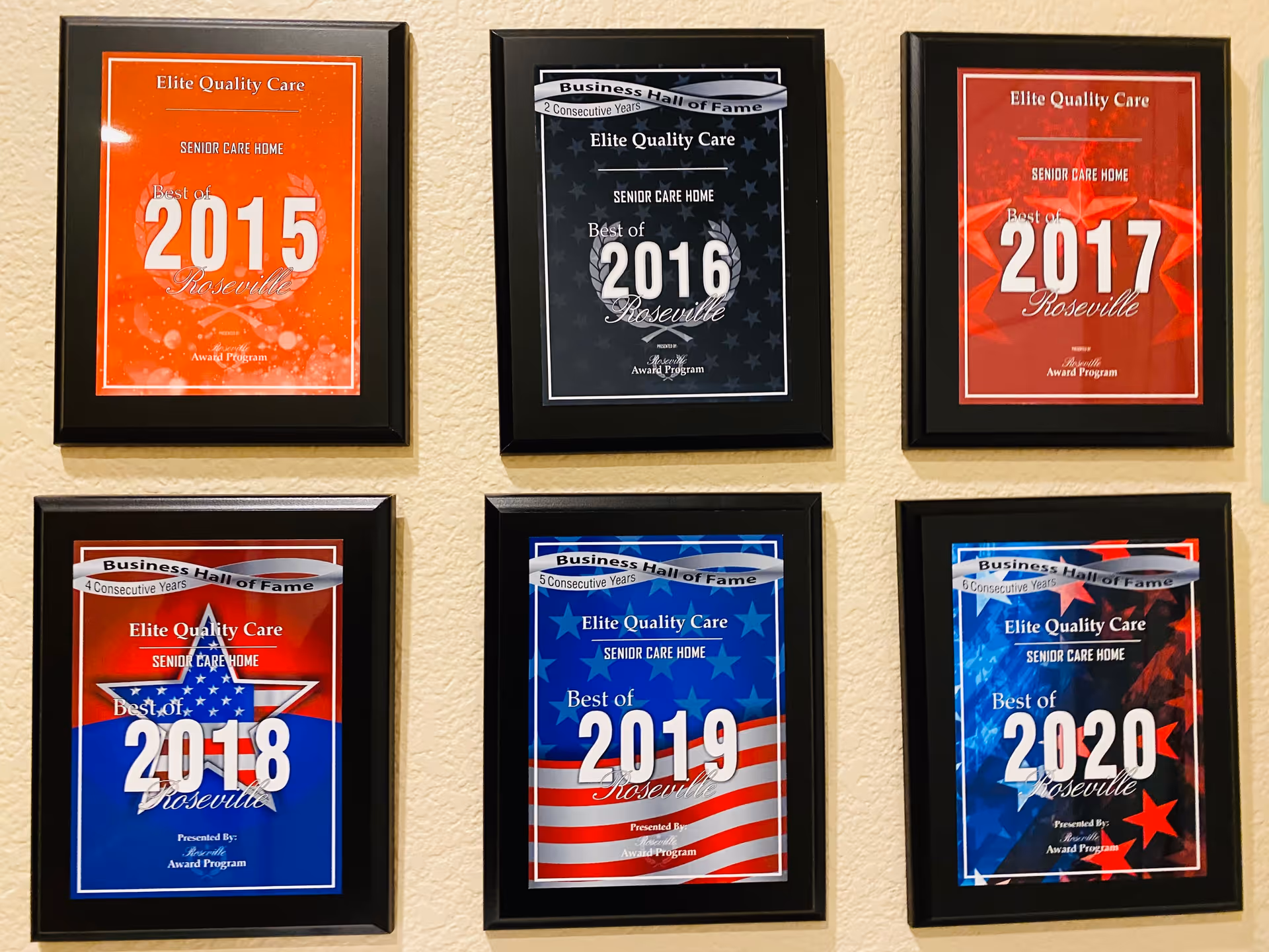 Six framed awards displayed on a beige wall, each recognizing Elite Quality Care senior care home as the Best of Roseville for the years 2015 through 2020. The awards have different colored backgrounds and some mention consecutive years in the Business Hall of Fame.