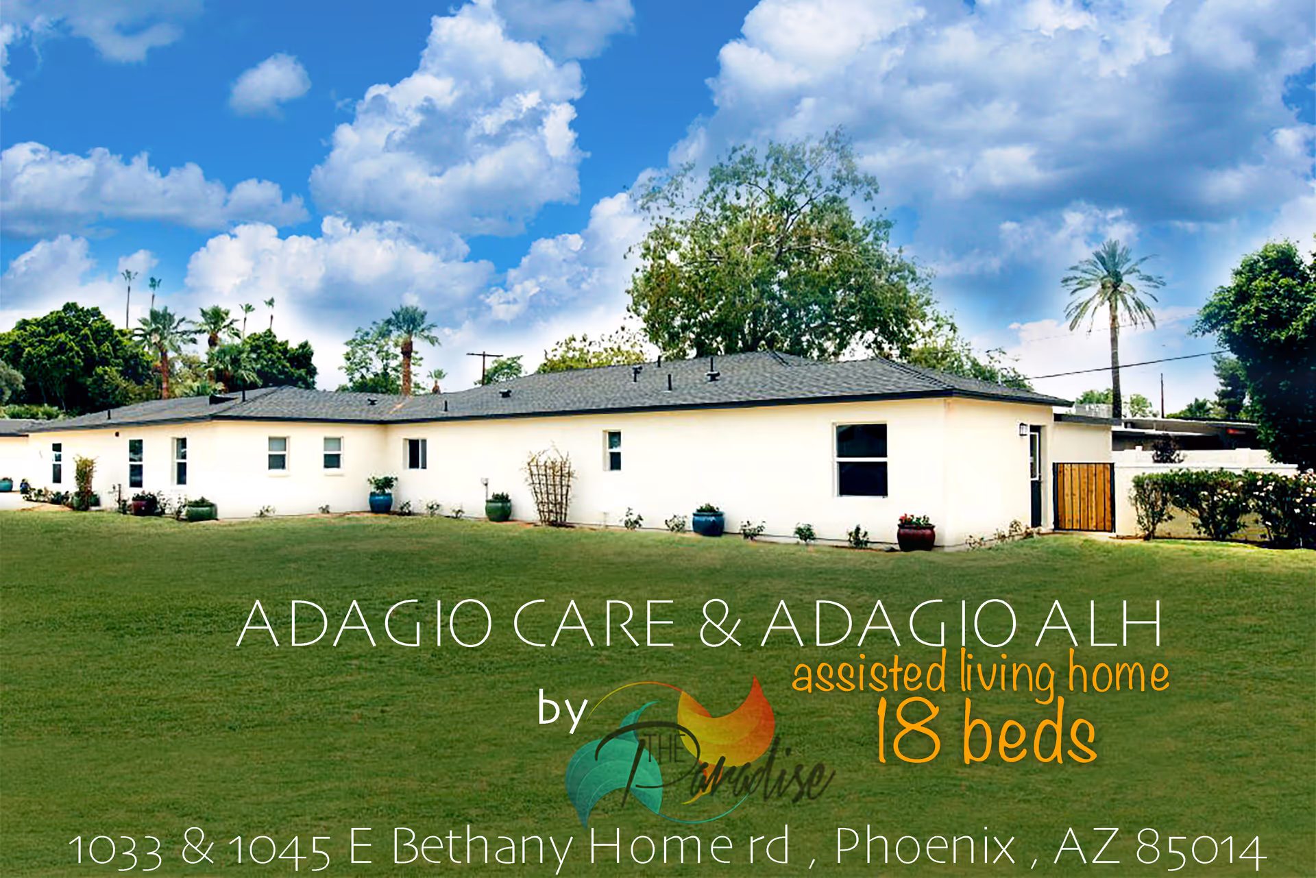 Single-story white senior living building with a lawn and potted plants under a blue sky.