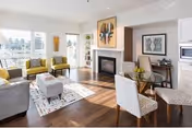 Bright living room in Willamette View Terrace senior facility with fireplace, lounge seating, and dining area.