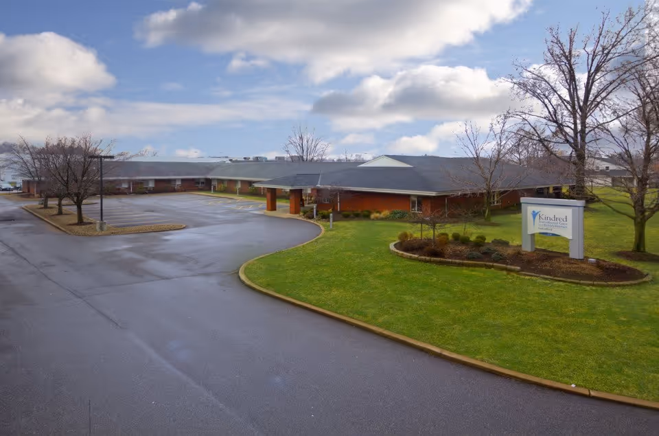 Exterior view of Heritage Healthcare of Painesville with a curved driveway and sign.