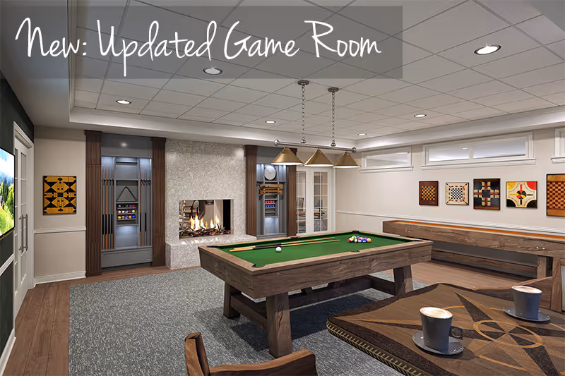 A modern game room featuring a pool table with balls arranged for a game, a fireplace with a fire burning, a shuffleboard table, and a table with two cups of coffee. The room has framed game boards on the walls, a carpeted floor, and pendant lights hanging above the pool table. There are also racks with pool cues and a door leading outside.