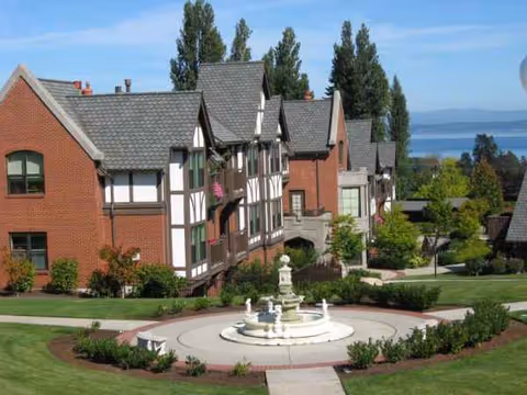 Franke Tobey Jones campus with brick Tudor style buildings surrounding a circular fountain.