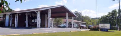 Front view of Eastview Rehabilitation and Healthcare Center with a covered driveway and parked cars.