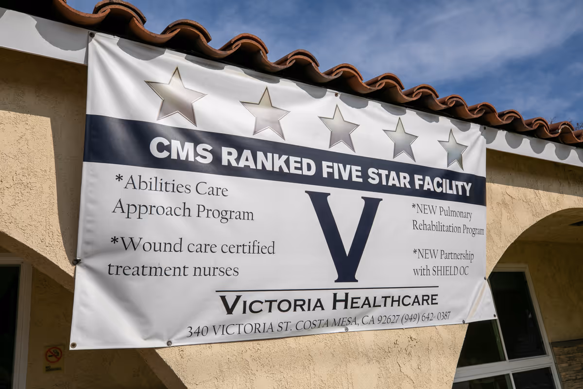 A large banner on a stucco building exterior announcing "CMS Ranked Five Star Facility" for Victoria Healthcare with its address.