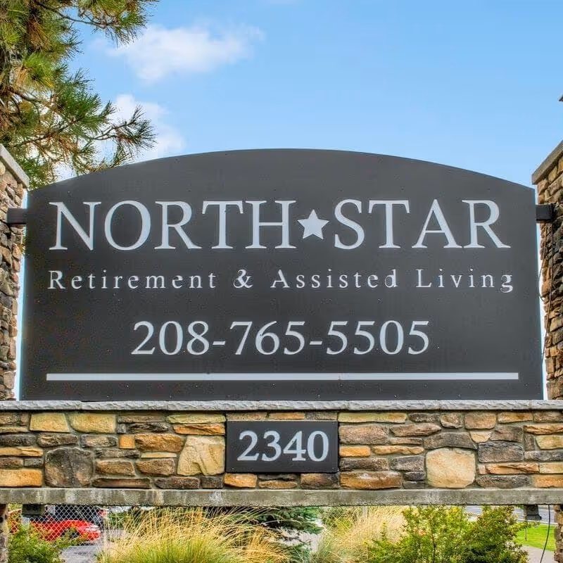 Stone-framed entrance sign reading 'NORTH STAR Retirement & Assisted Living' with phone number 208-765-5505 and address number 2340.