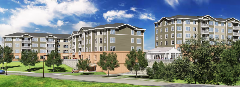 Exterior view of a large multi-story senior living facility named Maris Grove, featuring beige and light brown buildings with multiple windows, surrounded by green trees and grass under a partly cloudy blue sky.