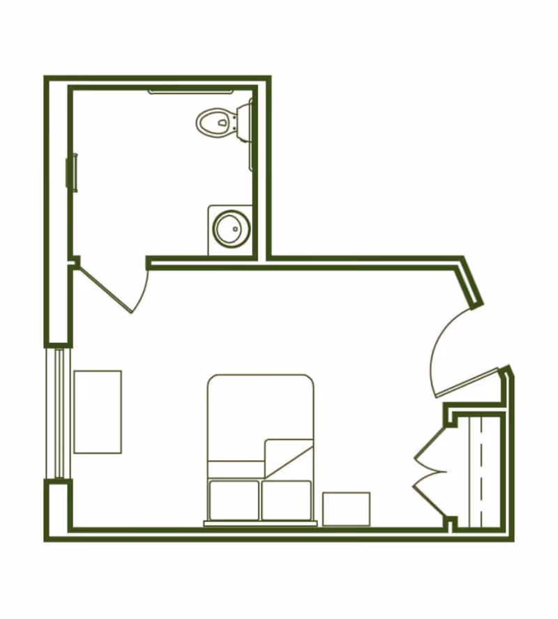Floor plan of a small living space with a bedroom area containing a bed and a side table, a closet near the entrance, and a separate bathroom with a toilet and sink.