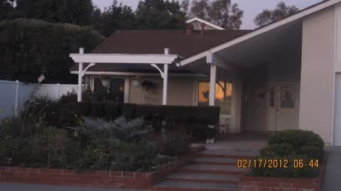 Front exterior view of Karry's Elder Care entrance with steps, garden, and walkway.