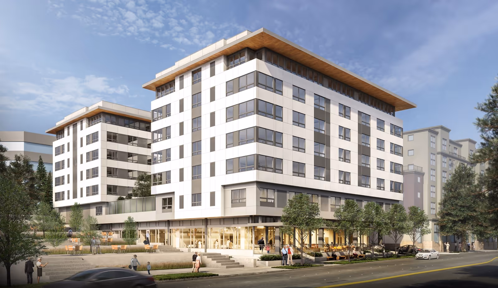 Modern multi-story senior living building with glass storefronts and outdoor seating.