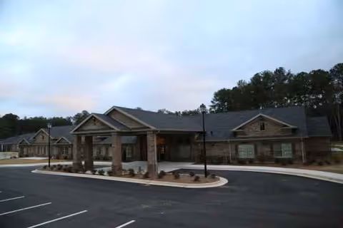 Exterior view of Magnolia Senior Living USA with brick entry and canopy over the parking lot.