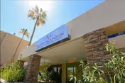 Exterior entrance of North Mountain Medical and Rehabilitation Center with palm trees.