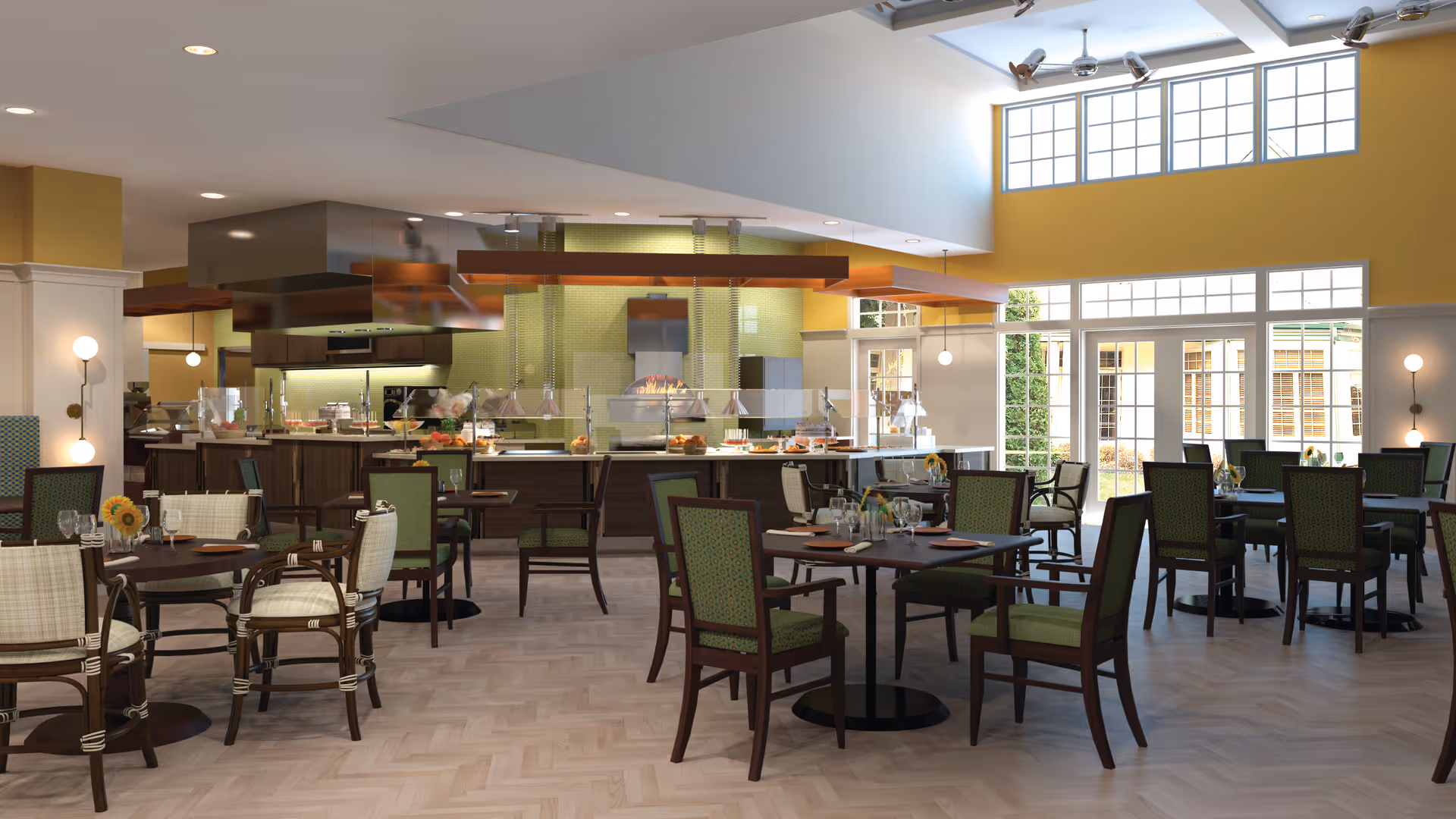 A bright and spacious dining room with multiple tables and chairs arranged neatly. The room features large windows allowing natural light to fill the space, yellow walls, and a modern buffet area with food displays and a pizza oven in the background.