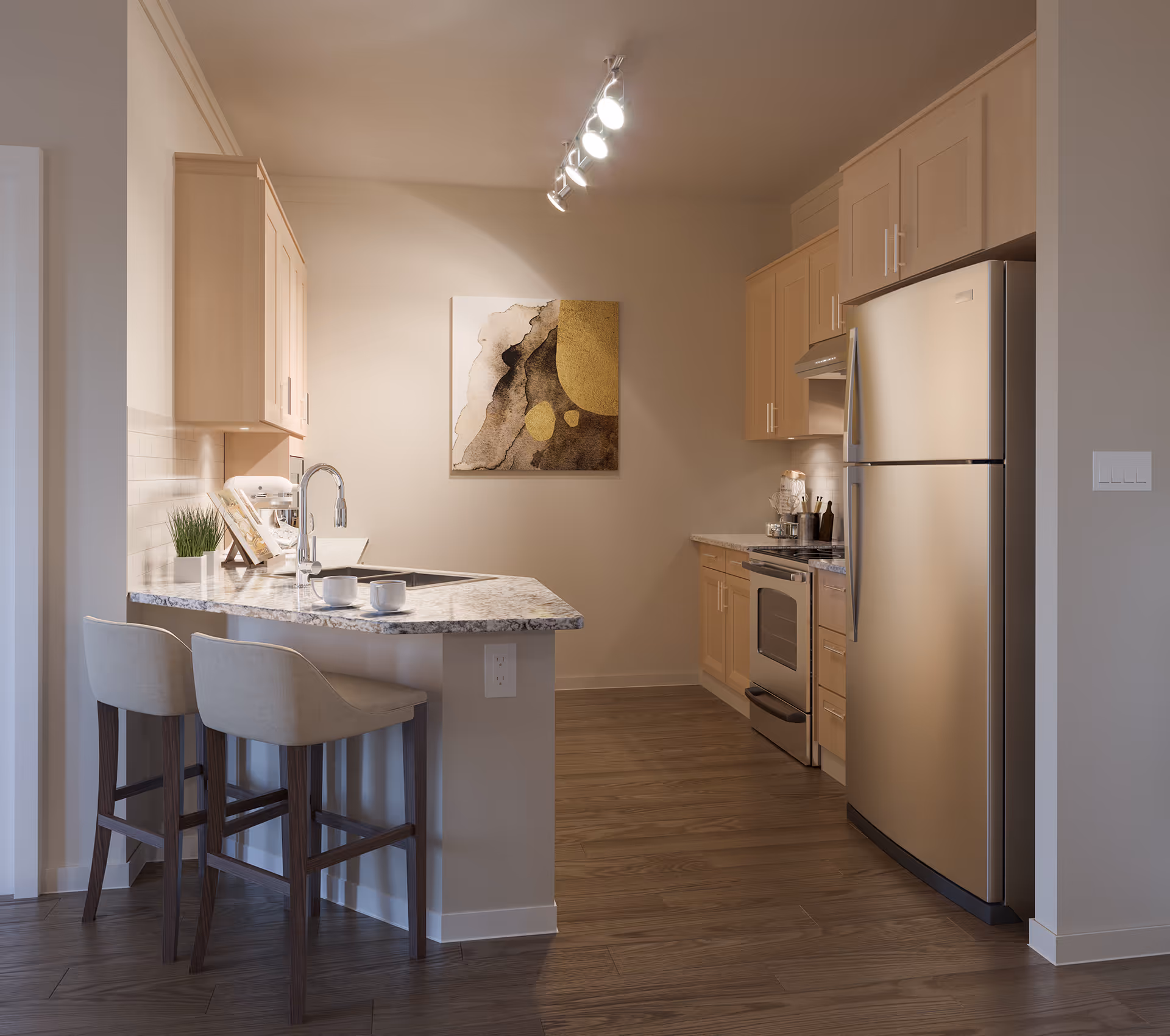 Modern kitchen with light wood cabinets, stainless steel refrigerator and oven, granite countertop with two beige bar stools, a sink with a faucet, two white cups on the counter, a small potted plant, a cookbook stand, and an abstract painting on the wall under track lighting.