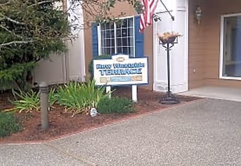 Front exterior of a senior living facility with a sign reading New Westside Terrace.