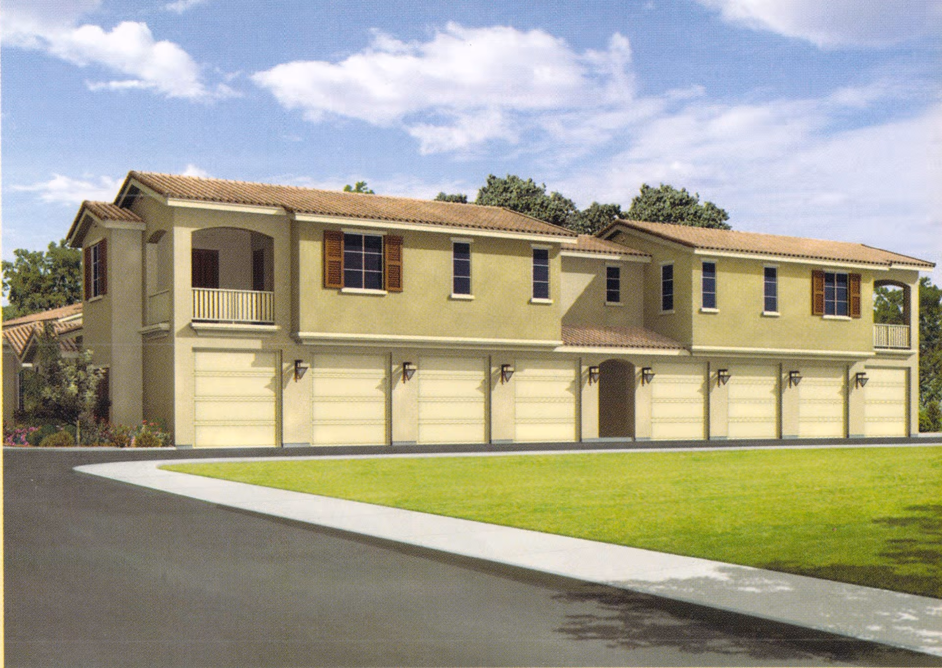 Two-story Mediterranean-style building with multiple garage doors and small balconies under a blue sky.