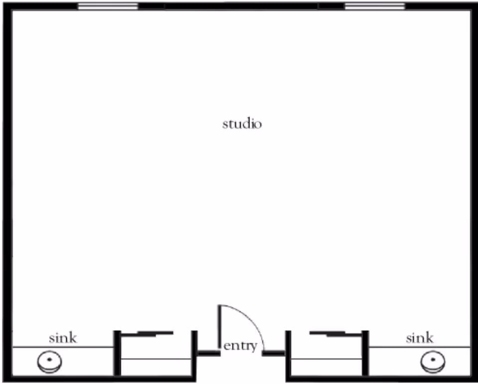 Floor plan layout of a studio apartment with an entry door in the center bottom. There are two sinks located on the left and right sides near the bottom corners. The main area is labeled 'studio'.