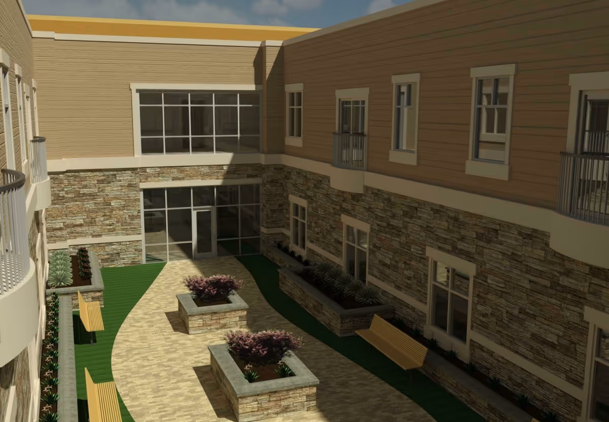 Outdoor courtyard area of a senior living facility with stone and wood-paneled walls, large windows, benches, and raised flower beds with plants and shrubs.