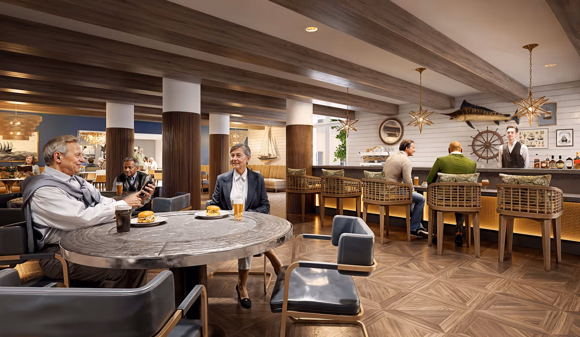 Residents sit at a round table and at a bar in a wood‑accented lounge and dining area with nautical decor.