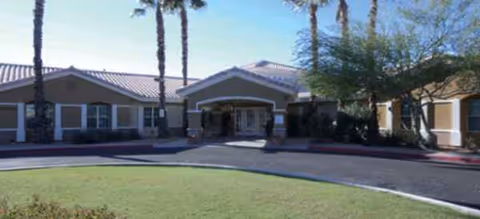 Front view of a Brookdale Camino del Sol senior living facility with a curved driveway.