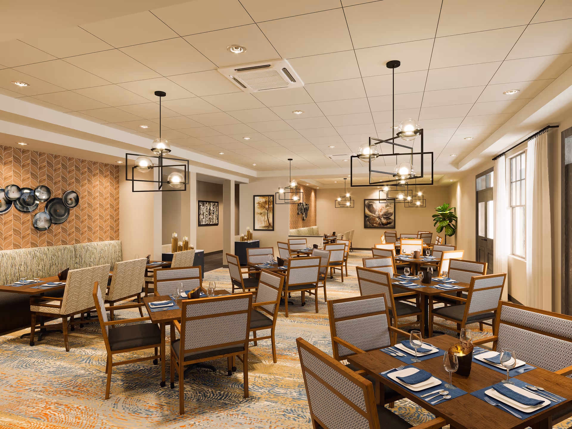 Spacious, well-lit dining room with multiple set wooden tables, chairs, and modern pendant lights.