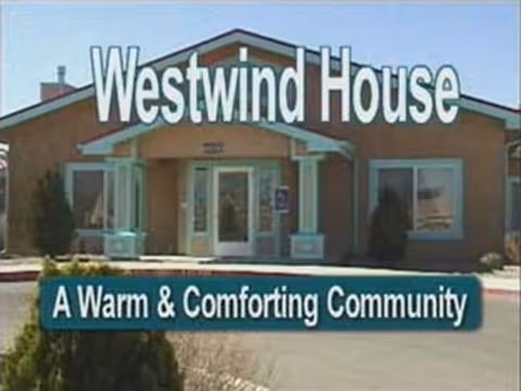 Front facade of Westwind House assisted living with prominent signage and the tagline 'A Warm & Comforting Community'.