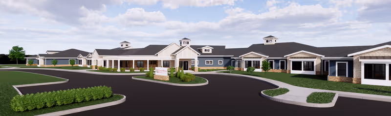 Exterior view of a single-story senior living facility named CountryHouse Residence, featuring a large building with multiple entrances, a dark roof, light-colored walls with stone accents, surrounded by landscaped greenery and a paved driveway under a partly cloudy sky.