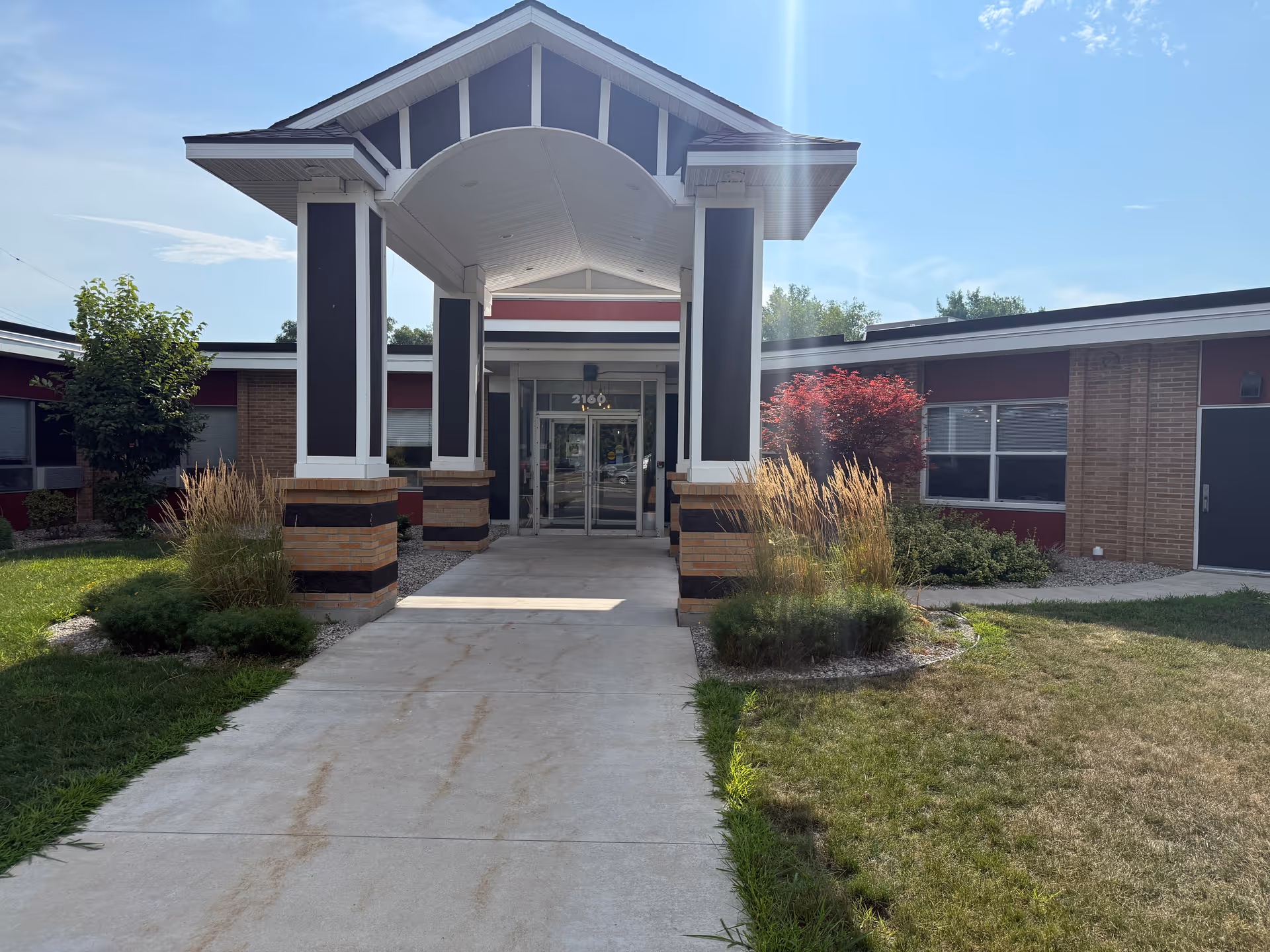 Entrance of Close to Home Assisted Living facility featuring a covered walkway and landscaped surroundings.