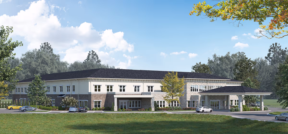 Exterior view of Landmark Lifestyles at Bryant facility with parked cars and green lawn.