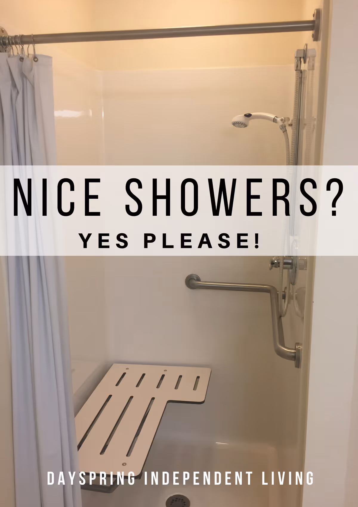 Accessible shower stall with a folding bench, grab bar, handheld showerhead, and shower curtain.