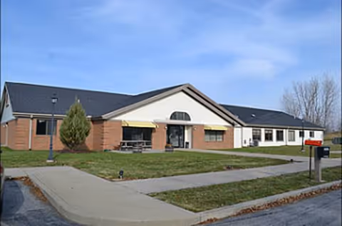 Fritz House: single-story brick senior living facility with front entrance, lawn, and walkway.