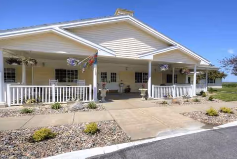 Front view of Carter Place Senior Living, a single-story building with a covered porch and planters.