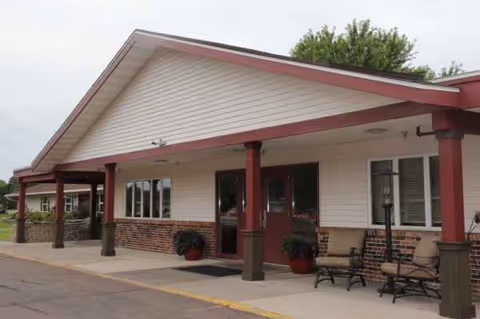 Exterior view of Oakbrook Health and Rehabilitation with a covered entrance and seating.