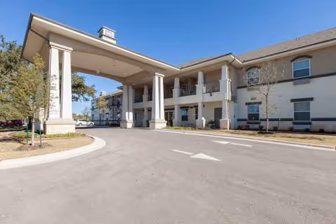 Exterior view of Truewood by Merrill Georgetown with a porte-cochere and driveway.