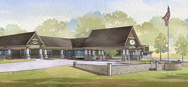 Watercolor-style rendering of a single-story building with a covered columned entrance, flagpole, driveway, and landscaped lawn.