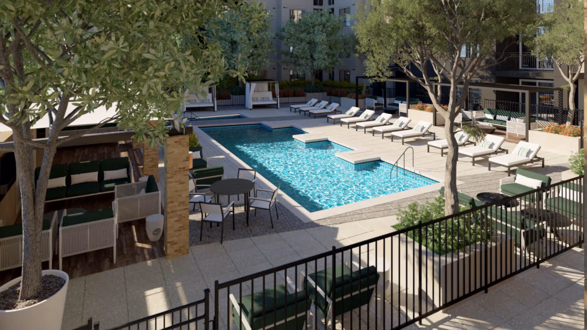 Outdoor courtyard with a rectangular swimming pool surrounded by lounge chairs, cabanas, trees, and patio seating.