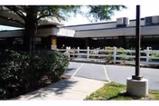 Exterior view of The Jewish Home Skilled Nursing and Rehabilitation facility with a white fence.