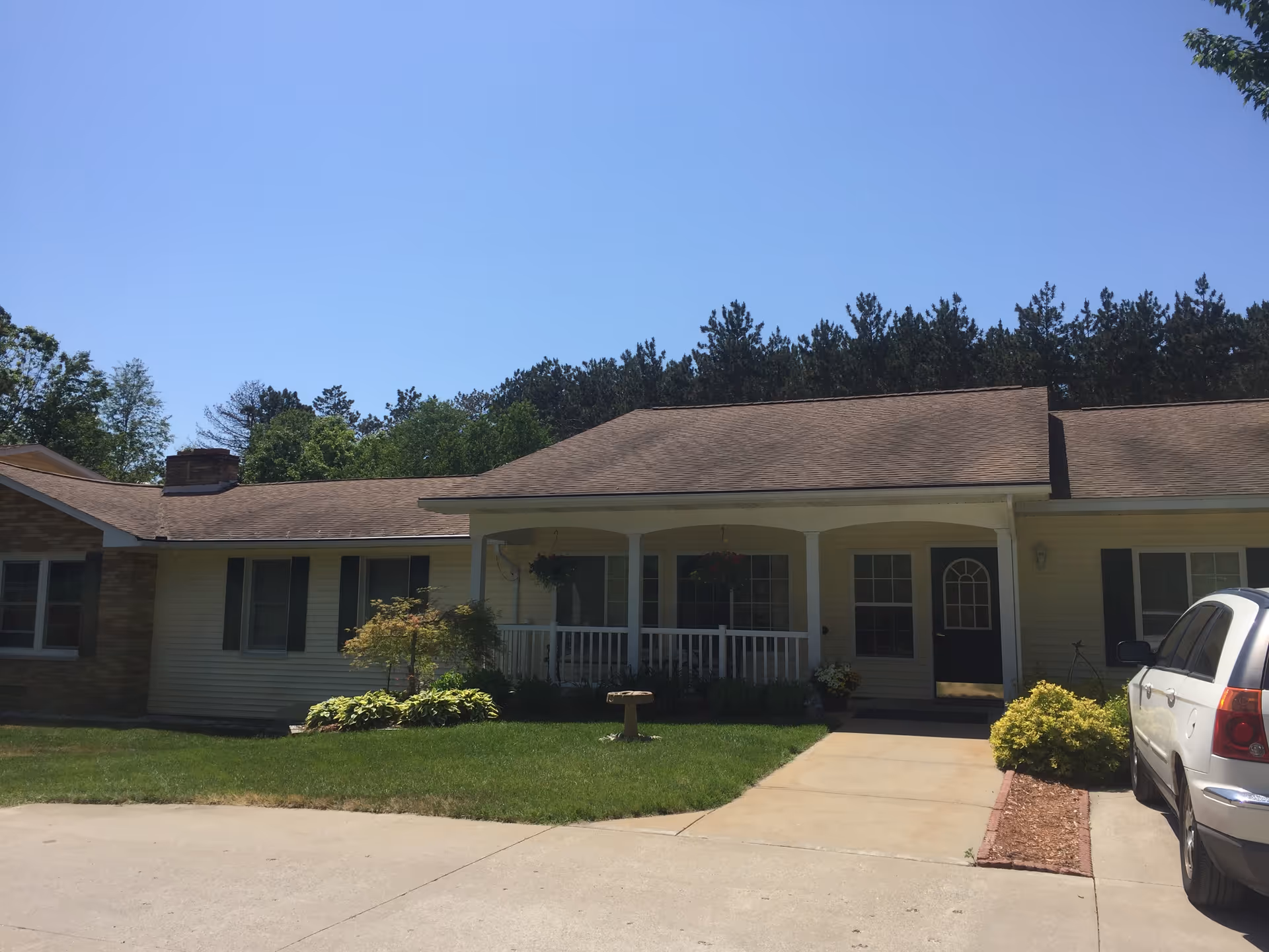 Exterior view of Agape Home Assisted Living facility with lawn and driveway.