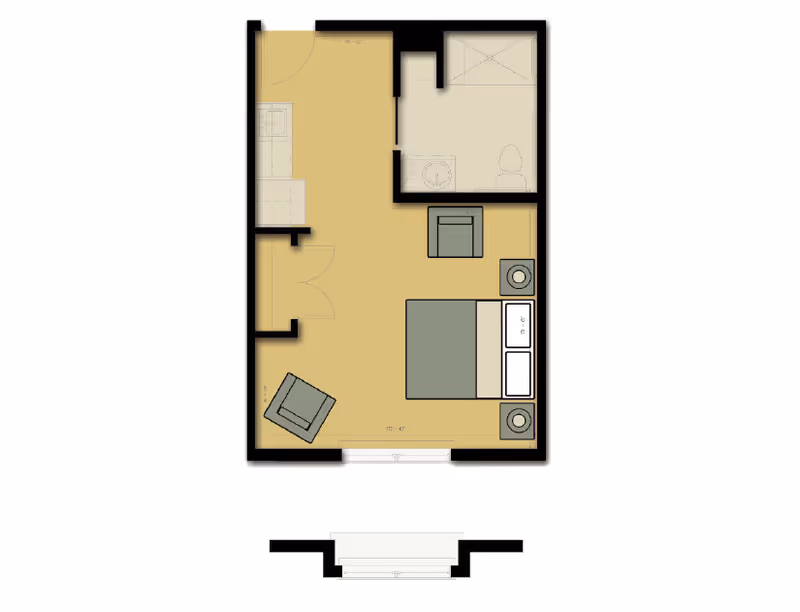 Top-down colored floor plan of a studio apartment showing a bed, seating area, kitchenette and a bathroom.