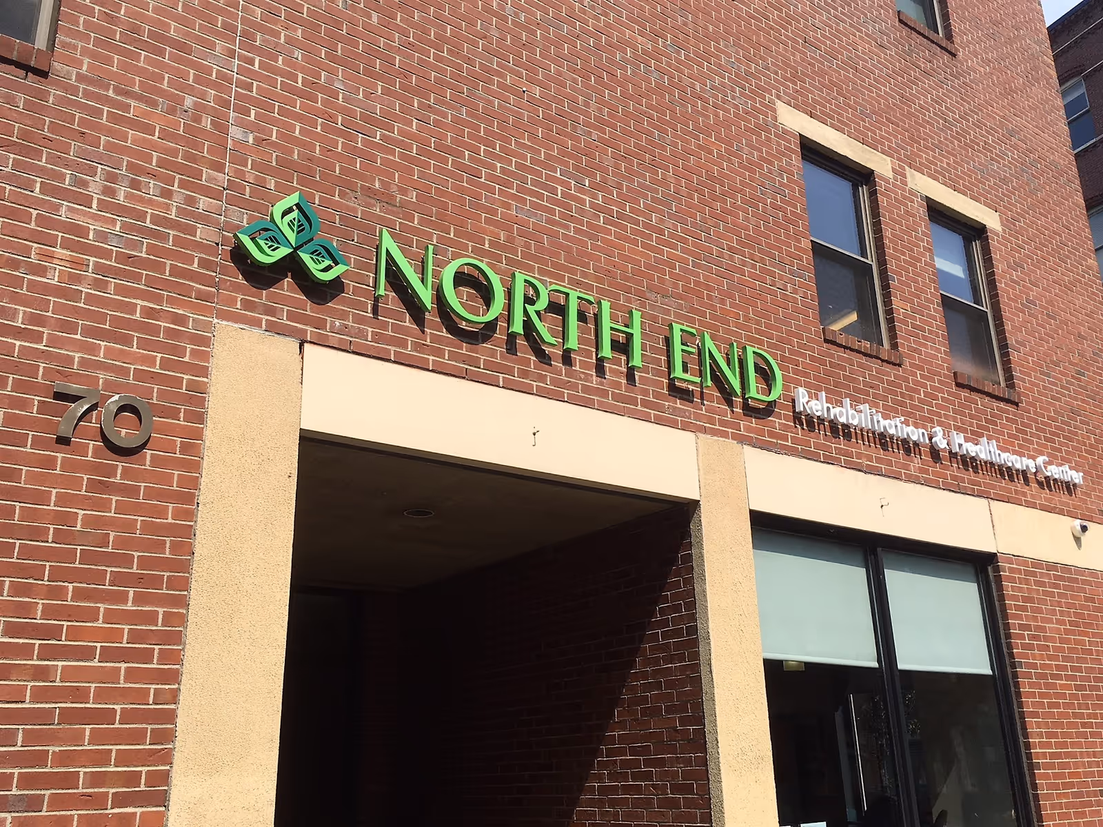 Brick building facade showing a green "NORTH END" sign for North End Rehabilitation & Healthcare Center above an entrance.