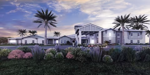 Exterior view of The Canopy at Azalea Grove with palm trees and landscaped grounds.