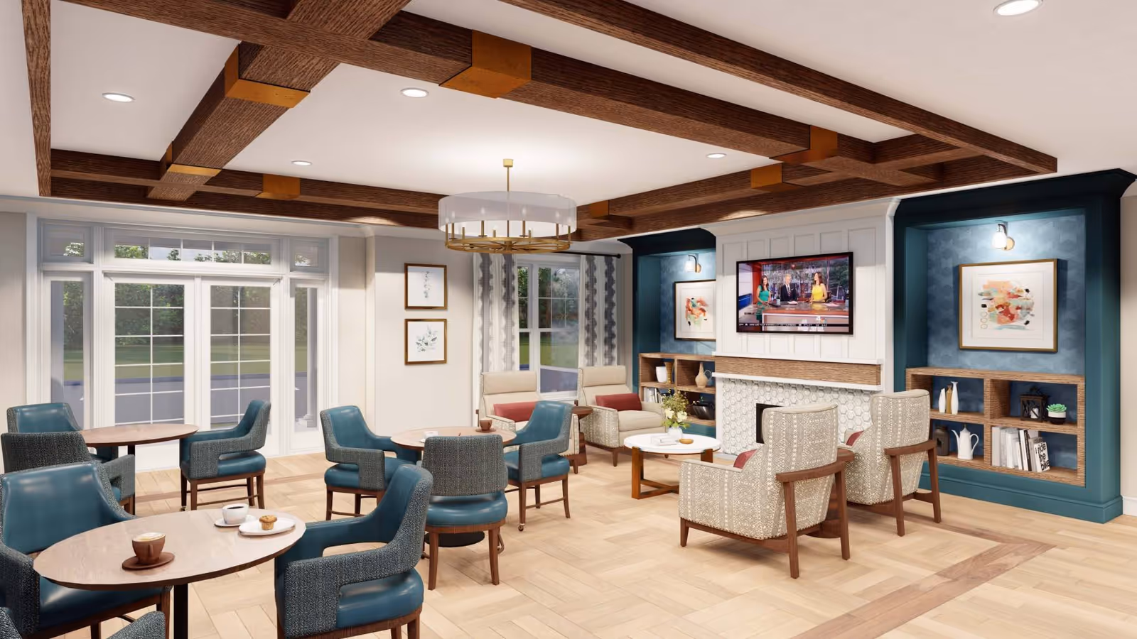 Communal lounge with multiple round tables and upholstered chairs facing a fireplace and wall-mounted TV, with large windows and decorative ceiling beams.