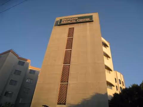 Tall beige hospital building with a sign at the top reading Brotman Medical Center.