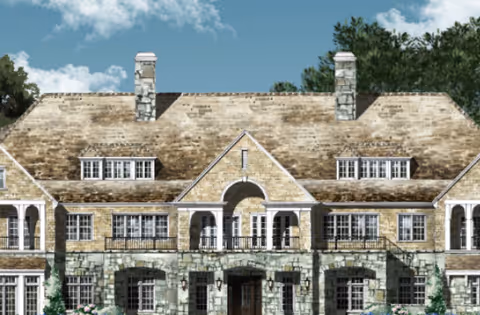 Front exterior view of a large senior living facility building with stone and brick facade, multiple windows, two chimneys, and a central arched entrance under a clear blue sky.