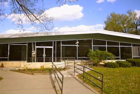 Exterior view of Gregory Ridge Living Center with glass front and accessible ramp.