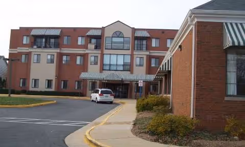 Exterior view of The Lincolnian Senior Residences building with driveway and entrance.