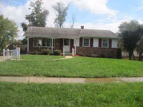 Single-story brick building with a manicured front lawn and sidewalk.