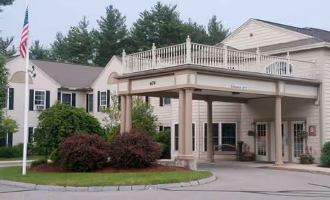 Front exterior of Benchmark Senior Living at Nashua Crossings with entrance canopy and landscaping.