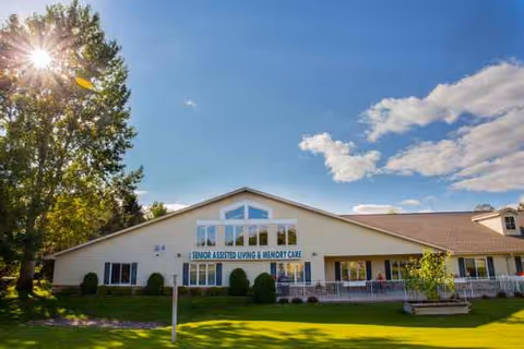 Front view of Encore Assisted Living and Memory Care building with a green lawn.