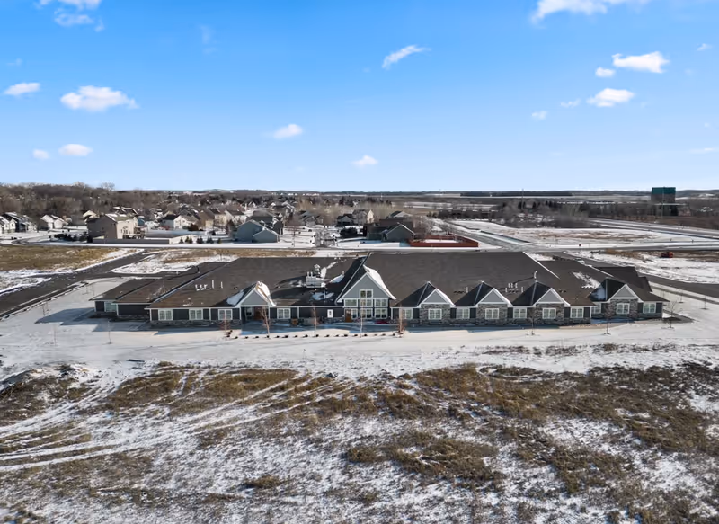 Aerial view of Suite Living Senior Care of Rosemount, snow-covered facility.