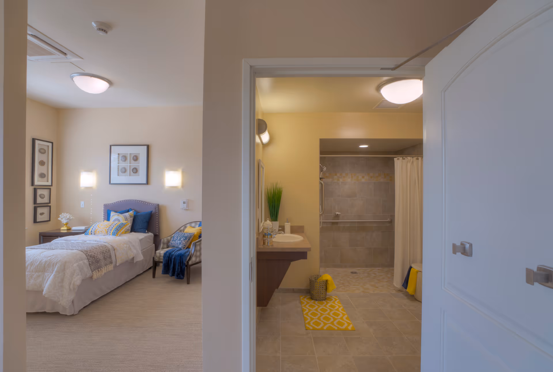 Interior view of a senior apartment showing a single bedroom on the left and an accessible bathroom with a walk-in shower on the right.